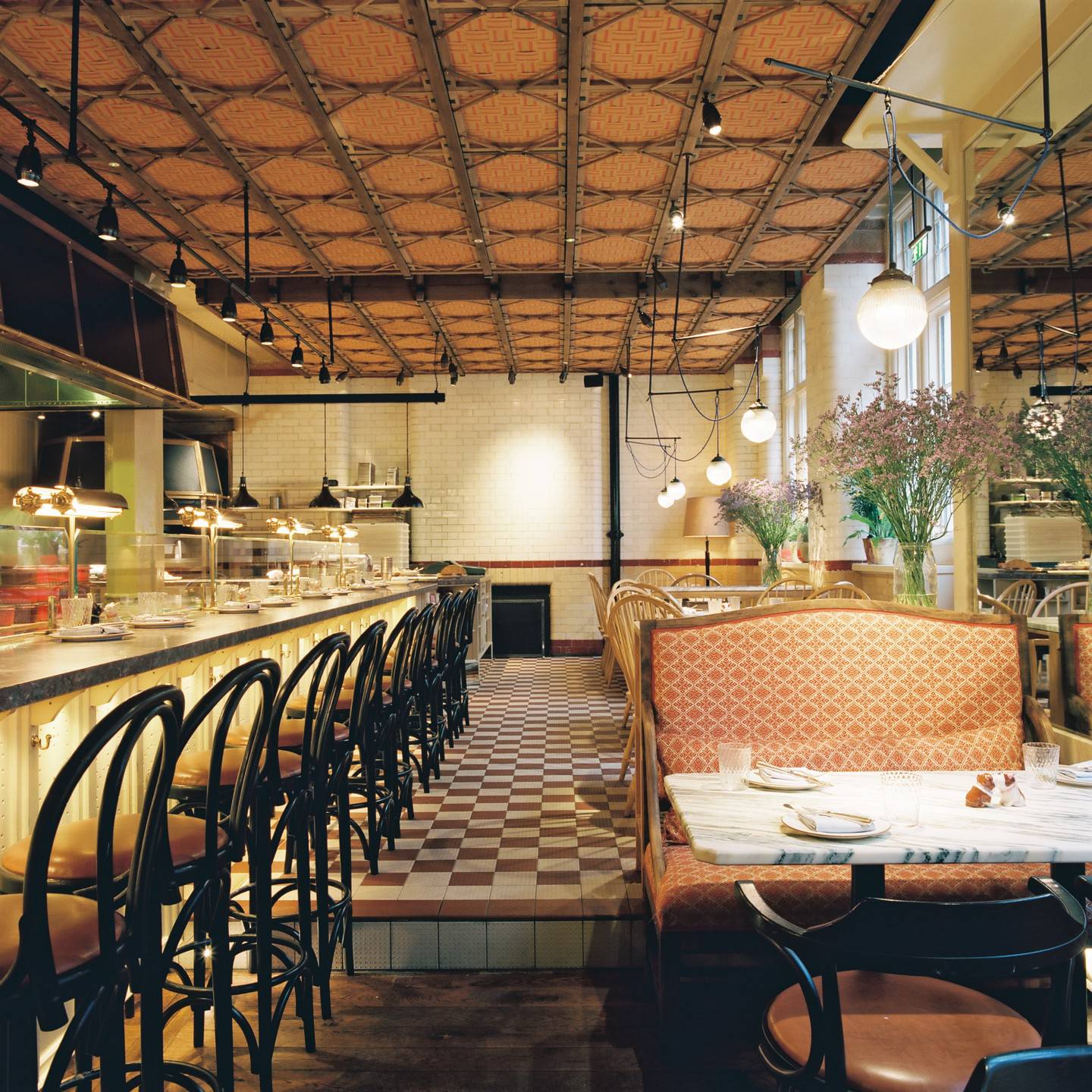interior bar with tall seating and restaurant with table seating