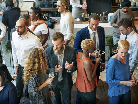 A group of people talking whilst attending a conference