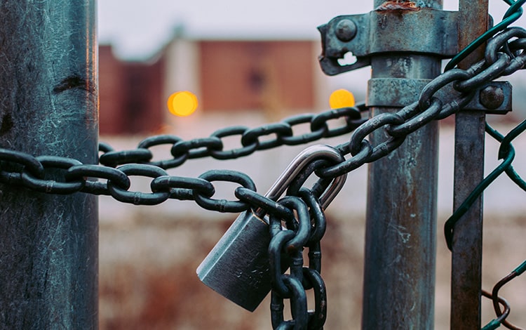 A close up of a padlocked gate