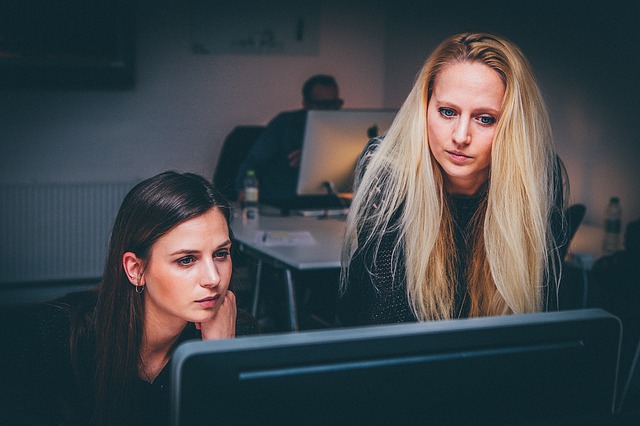 Two women looking at a computer screen in an office