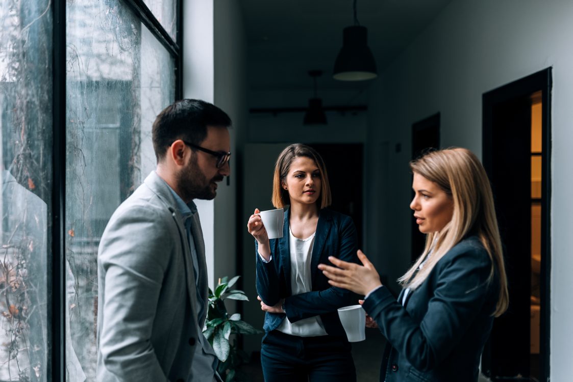 how to bite your tongue at work; collegues having a serious conversation