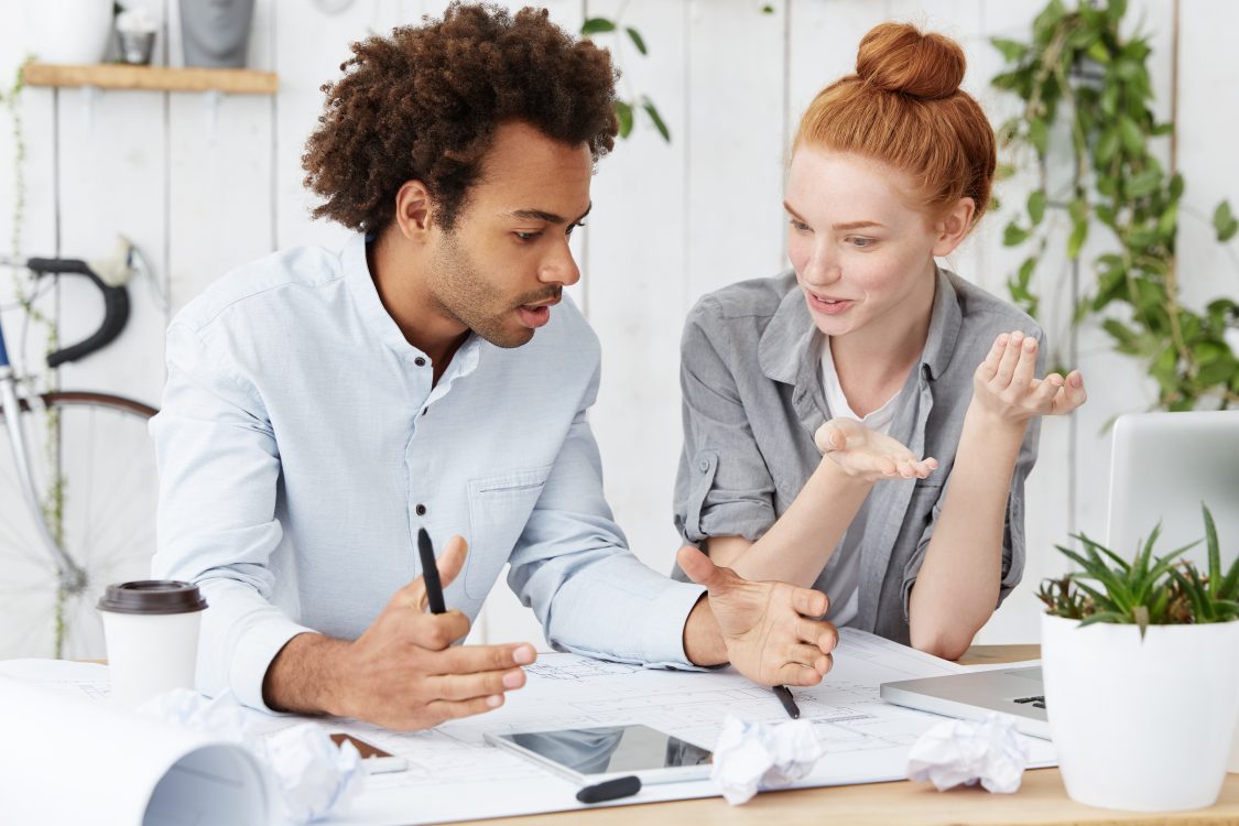 Body language at work; Two colleagues having a discussion 