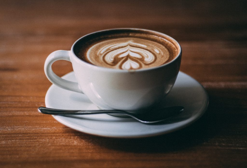 Frothy coffee in a teacup and saucer