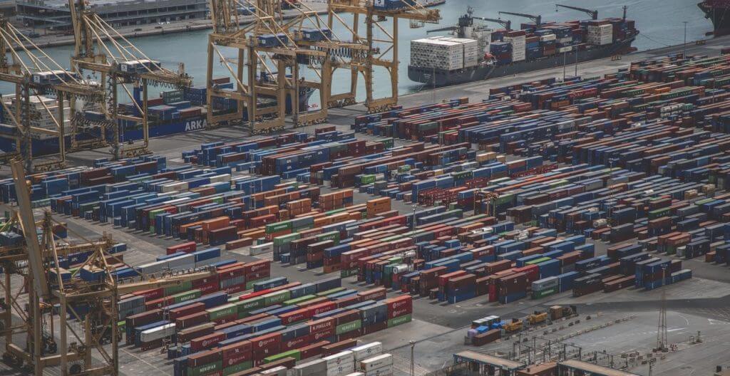 A aerial view of industrial docks and containers waiting to be shipped