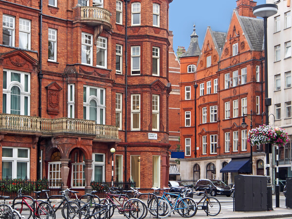 orange brick buildings with bike in racks in front