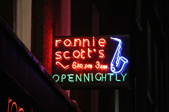 neon sign at night of Ronnie Scott's Open Nightly 